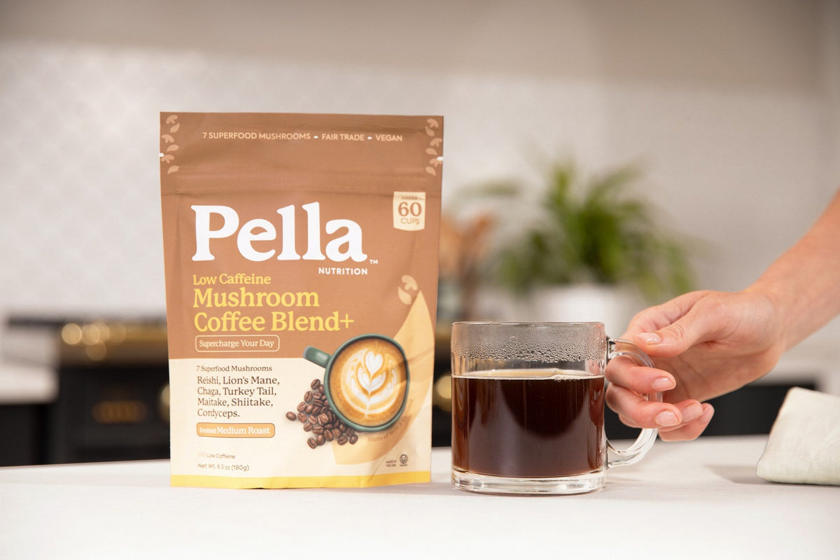 Low Caffeine mushroom coffee bag beside a mug of coffee in a warm kitchen