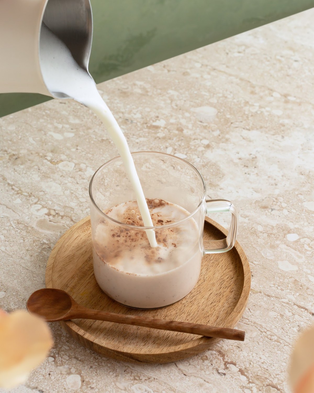 Milk being poured into a glass of Mushroom Hot Chocolate+