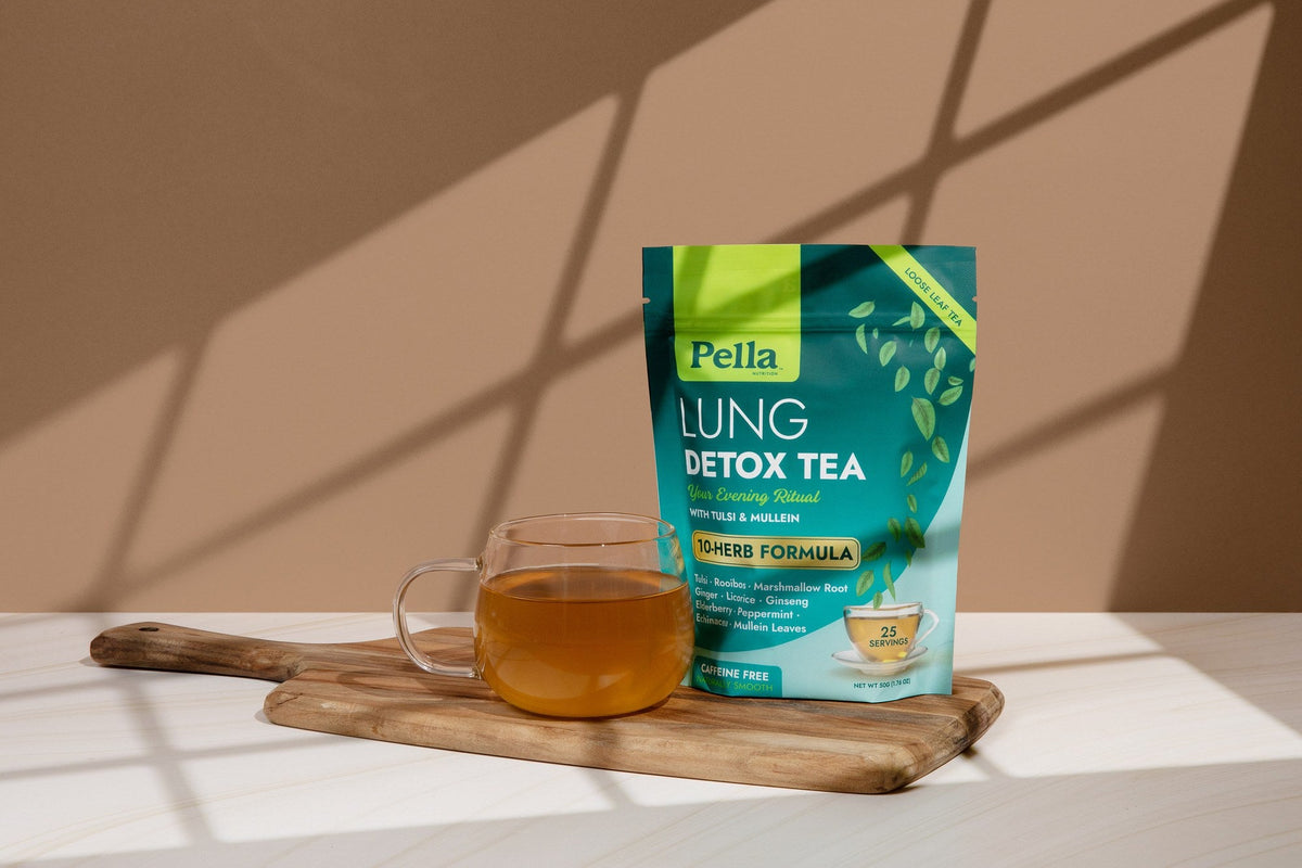 Lung Detox Tea pouch on a wooden board with a glass of brewed tea