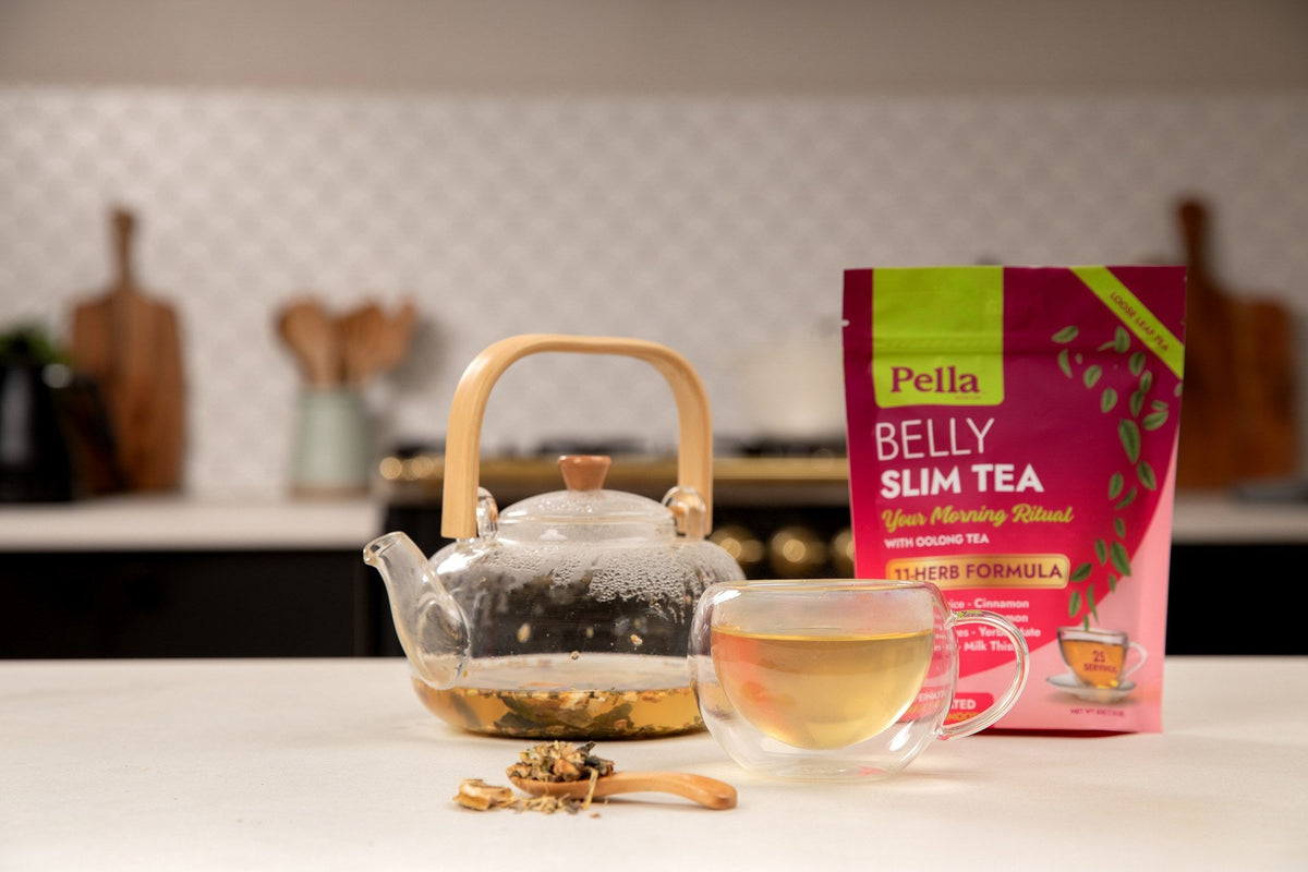 Belly Slim Tea pouch beside a glass teapot and a cup of tea