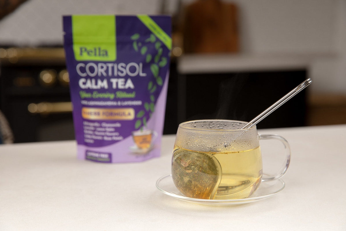 Cortisol Calm Tea pouch with a cup of tea on a kitchen counter
