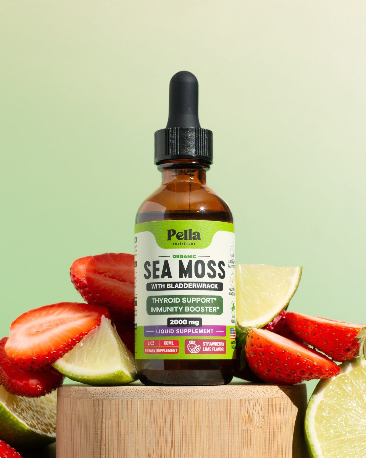Sea Moss Drops bottle with strawberries and limes