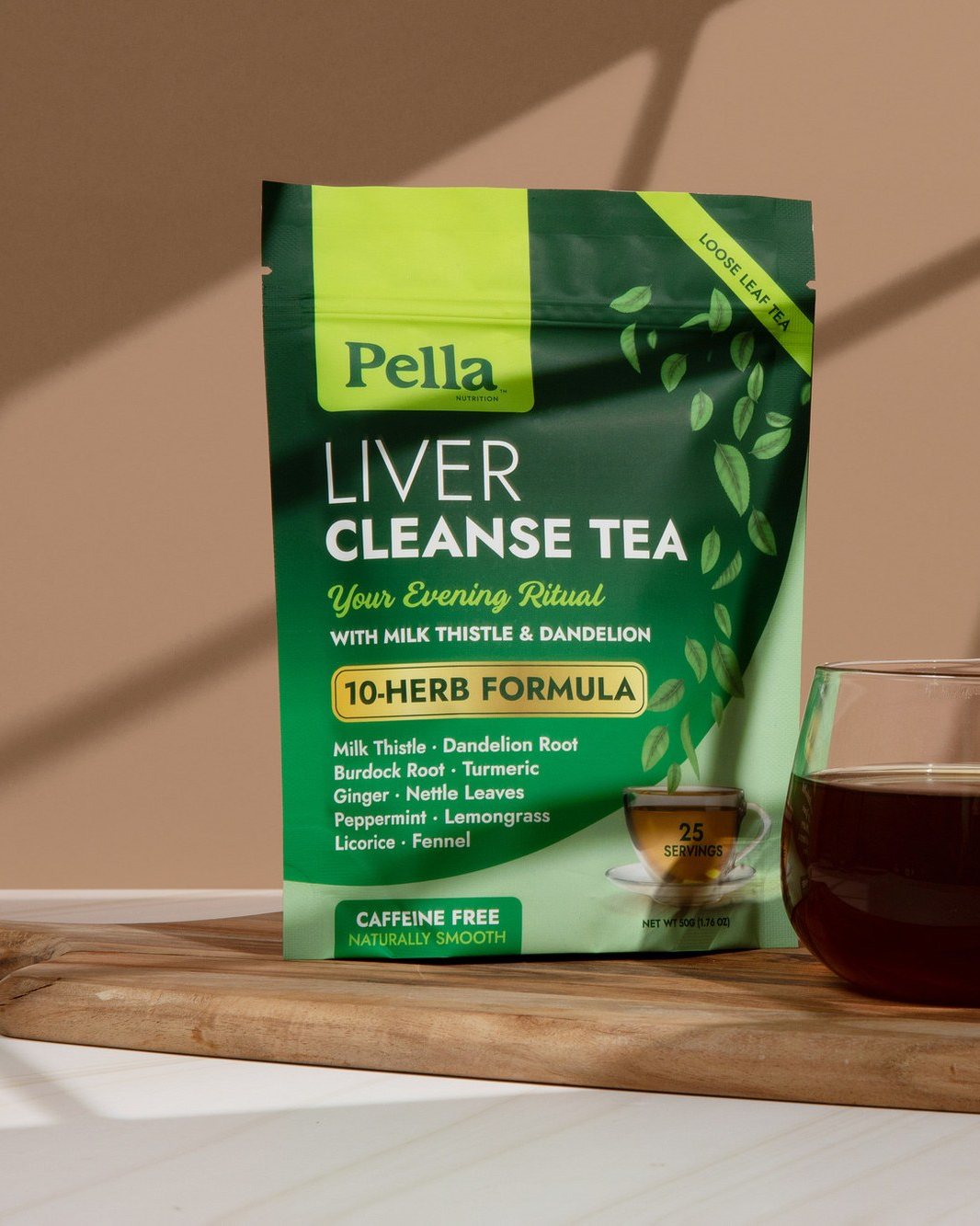 Liver Cleanse loose leaf tea pouch with a cup of golden tea