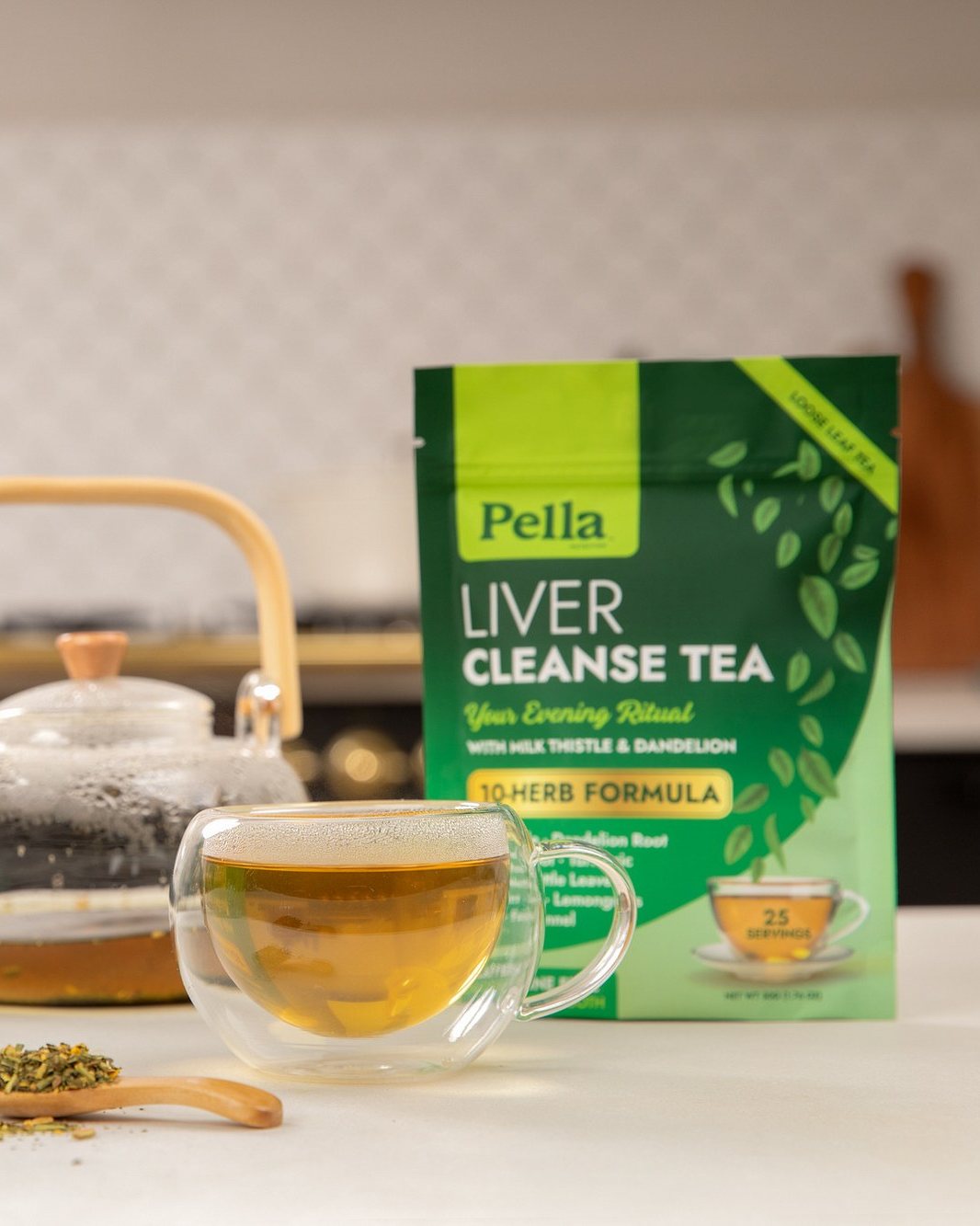 Liver Cleanse tea pouch beside a glass teapot and a cup of tea