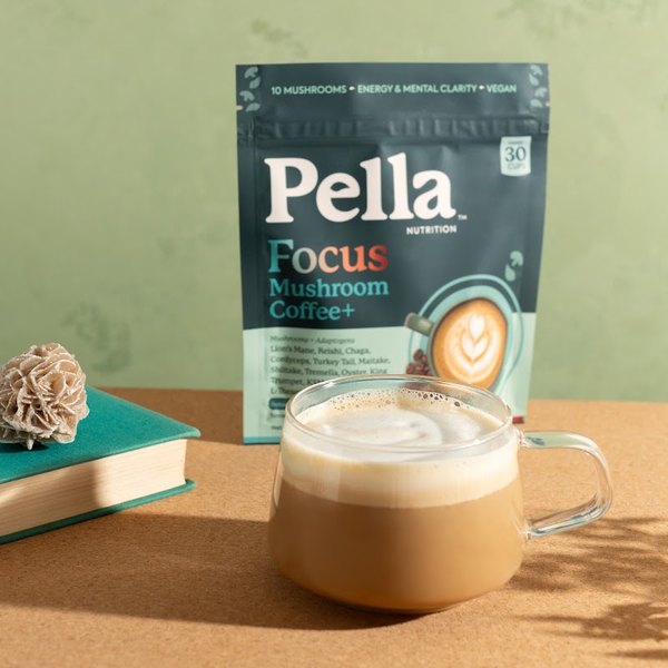 A Pella Focus coffee latte in a mug next to the bag