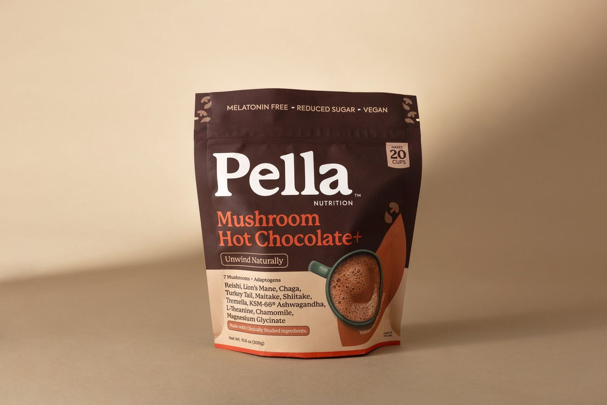 A bag of Pella Mushroom Hot Chocolate with a frothy mug