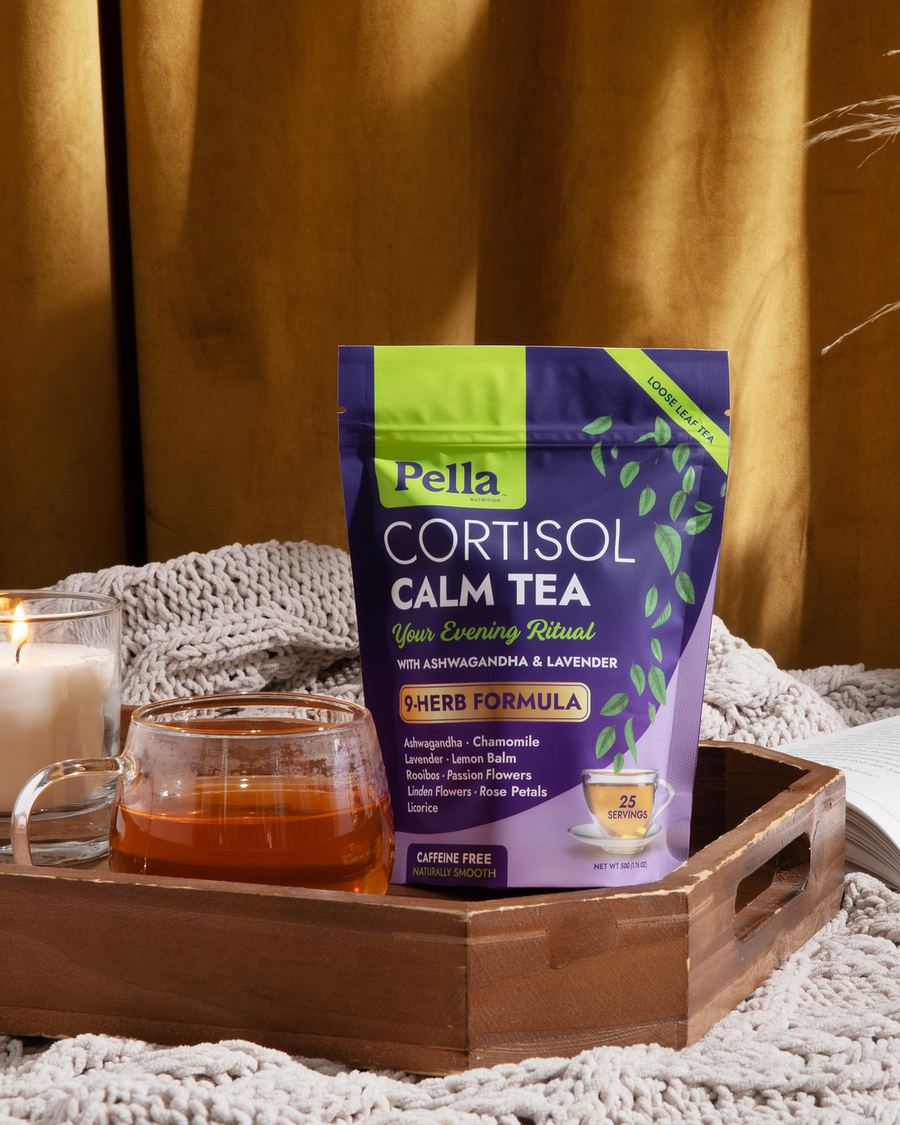 A bag of Pella loose-leaf tea beside a cup of tea